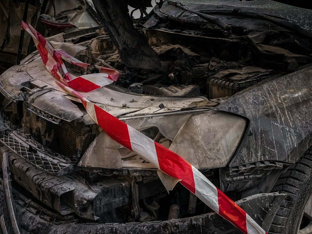 Close-up of a wrecked car covered with safety tape in Kyiv, Ukraine.