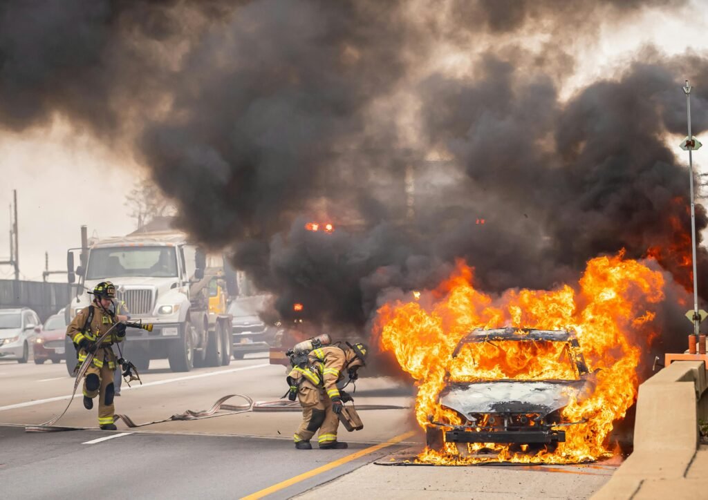 pexels-photo-14299430-14299430 Dramatic scene of firefighters extinguishing a car on fire on a highway in Springfield, VA.