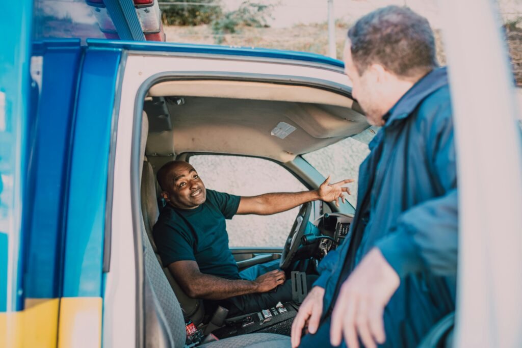 Emergency medical technicians engaged in conversation while preparing for duty in an ambulance.